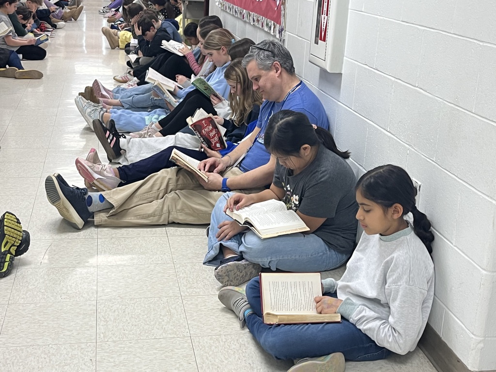 Students and teachers engrossed in reading.