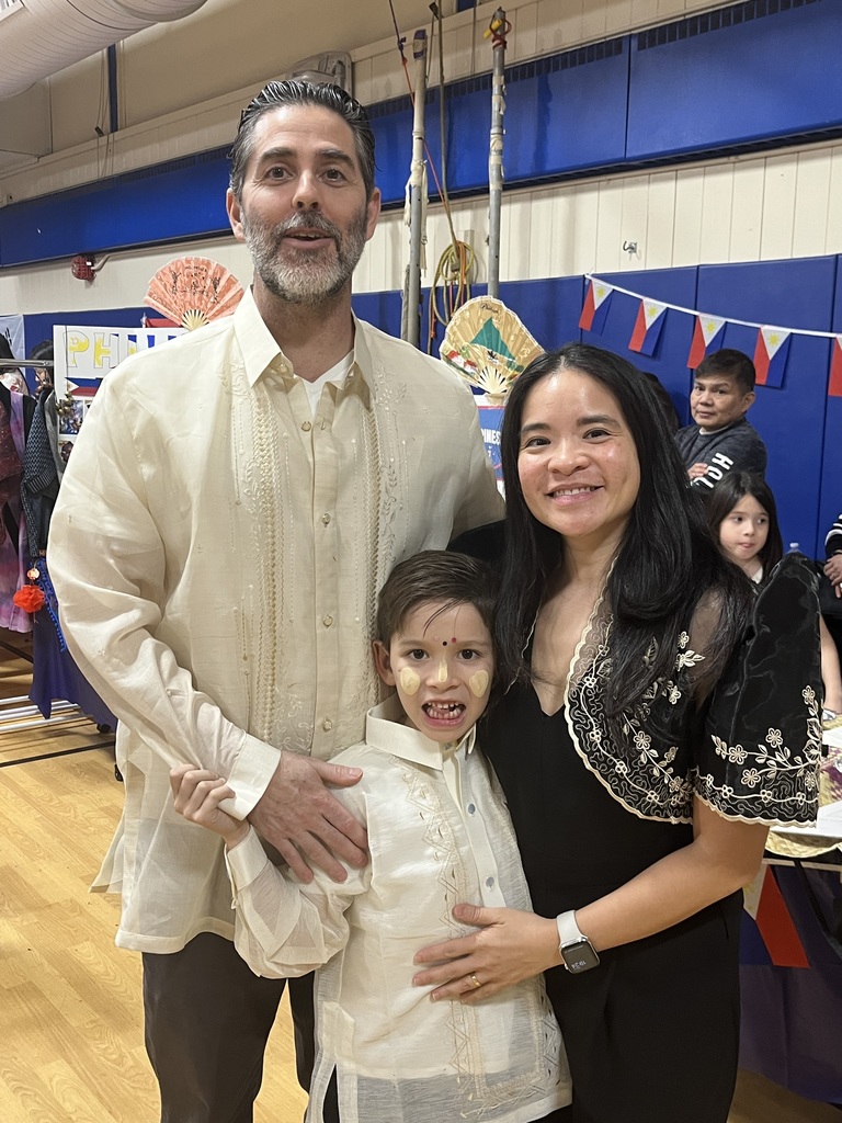 A family enjoying their evening and proud to share their traditional attire from the Philippines. 