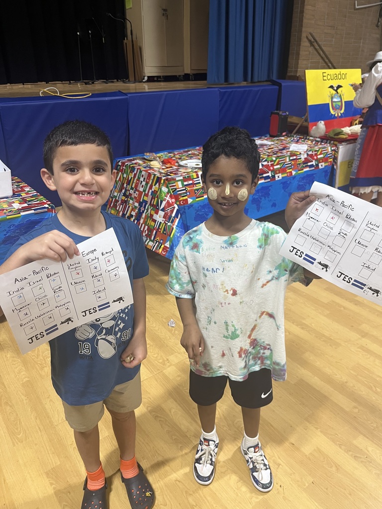 Two students show off their passport completion.