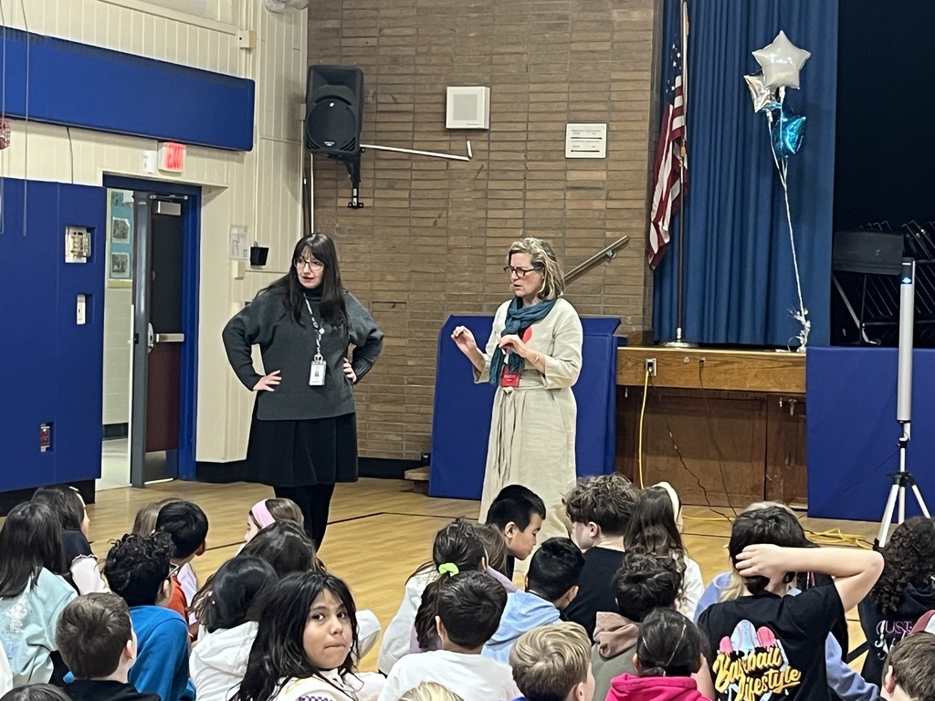 Author and librarian select students to give ideas for the illustration.