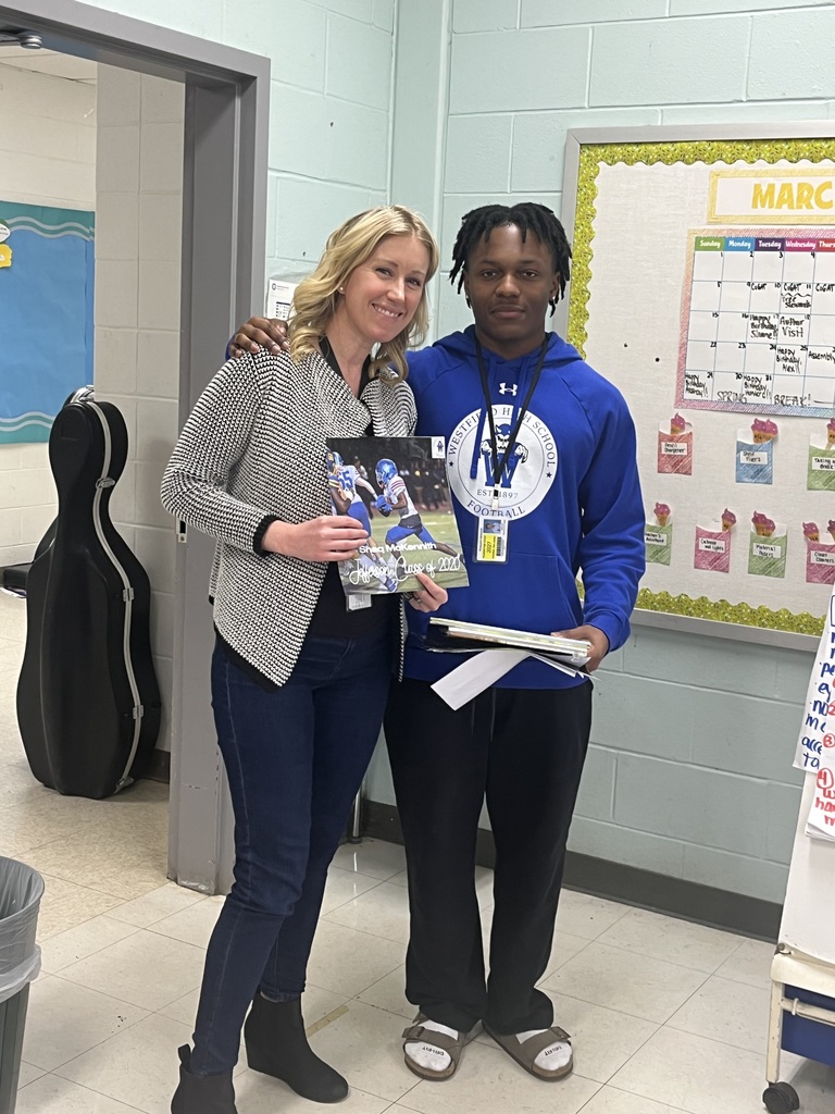 WHS student is photographed with his 4th grade teacher.
