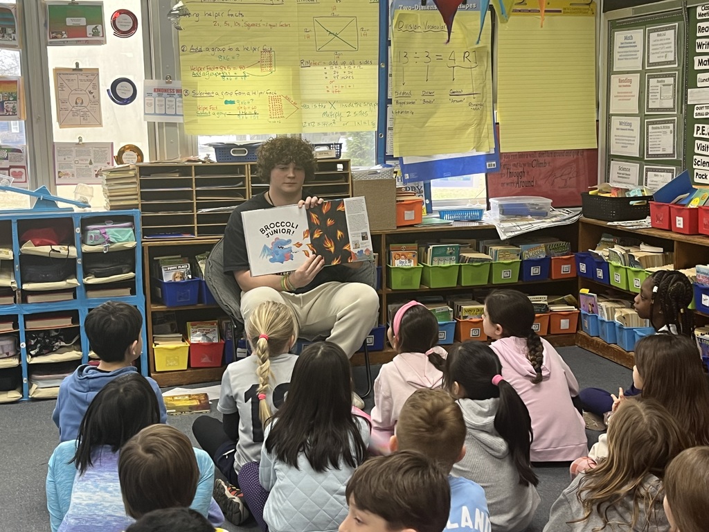 WHS football player reads to students.