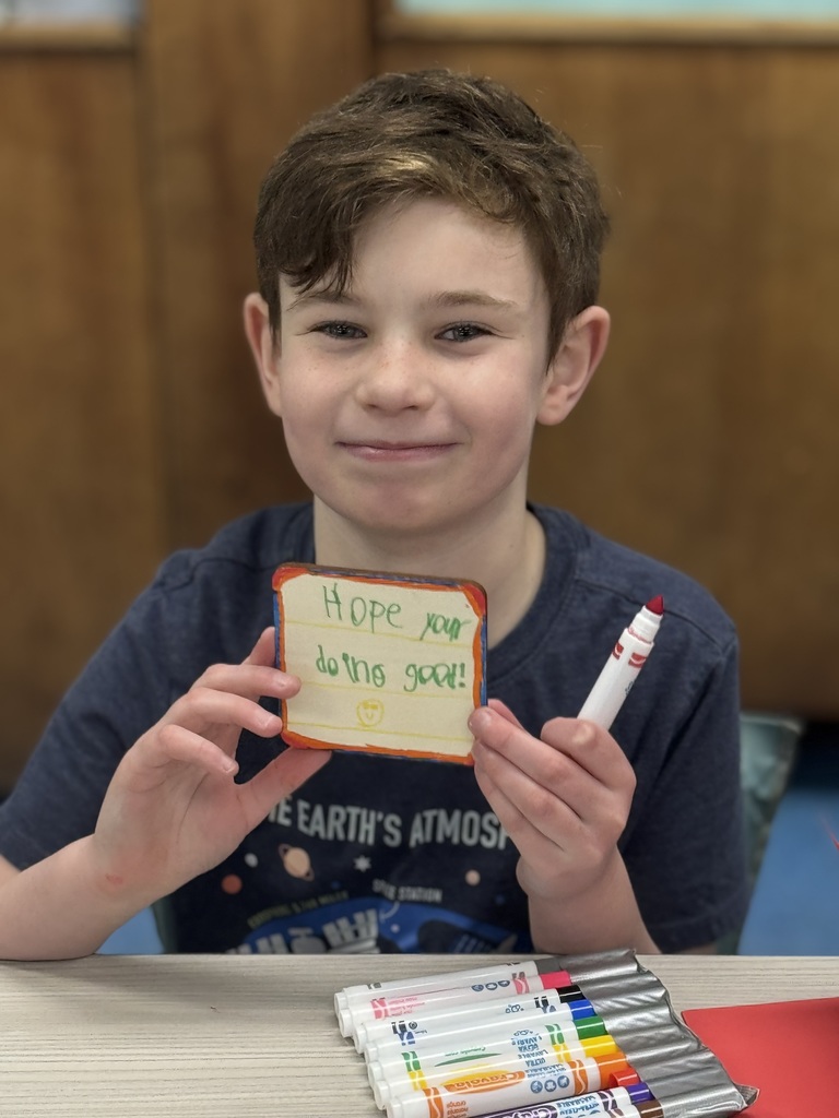 Student proud of the card he made.