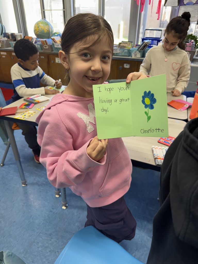 Student proud of the card she made.