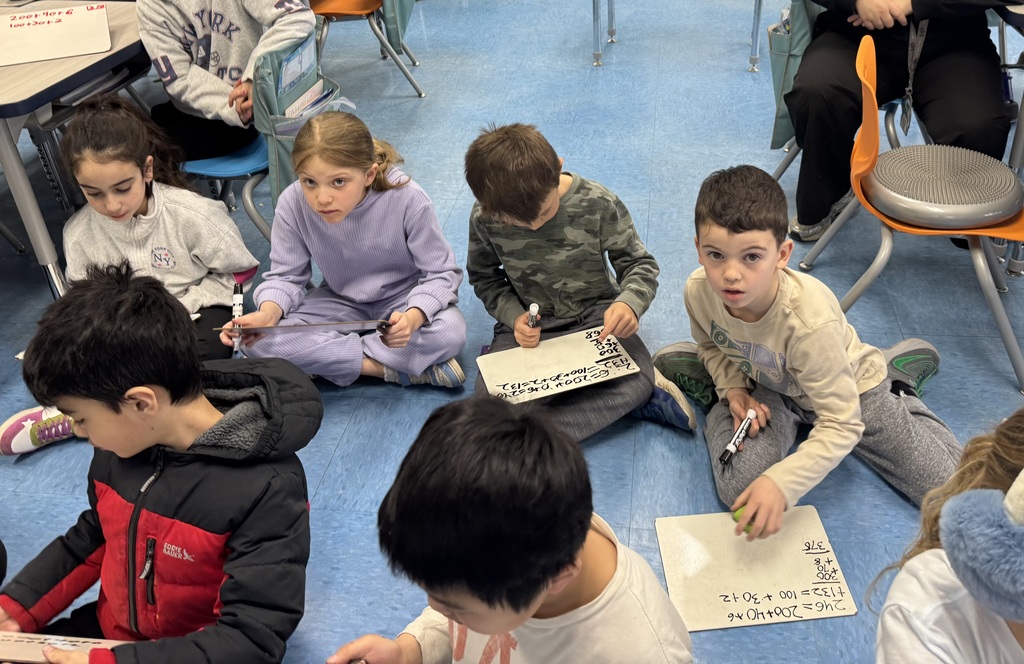 Students are practicing 3 digit addition.