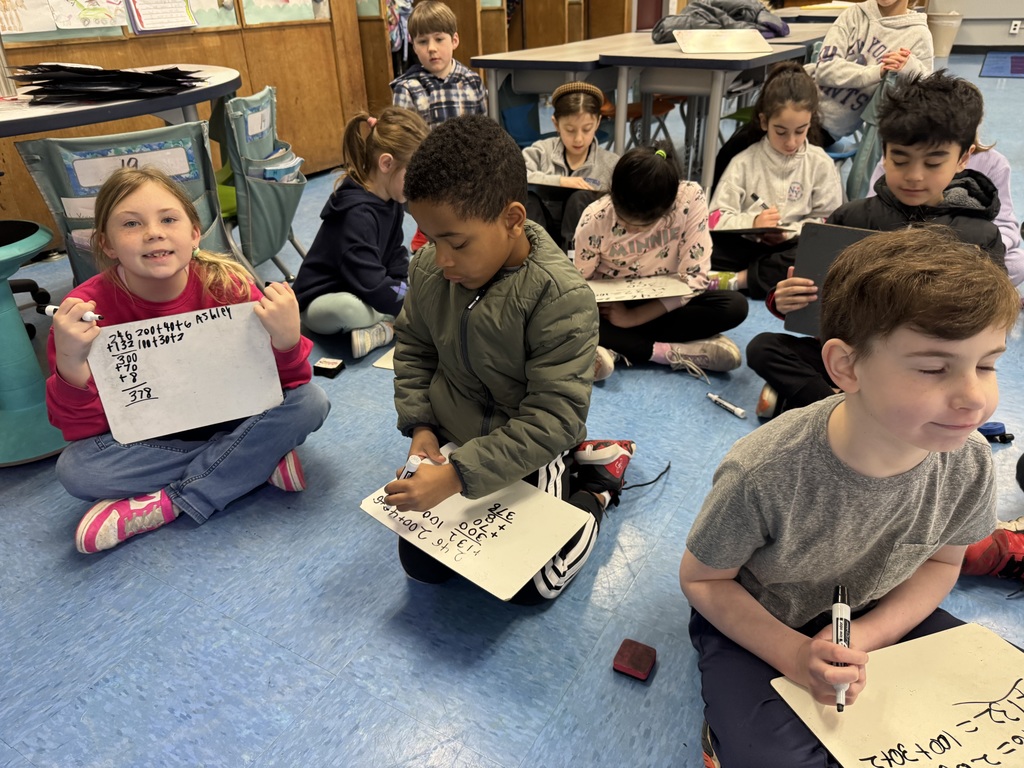 Students are practicing 3 digit addition.