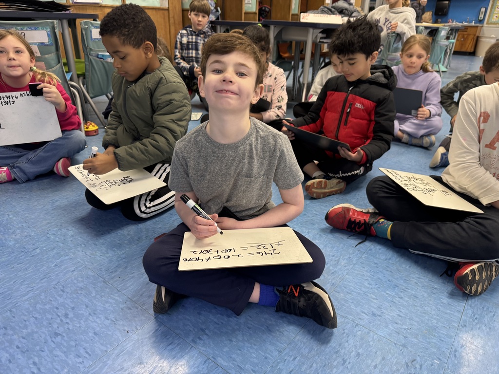 Students are practicing 3 digit addition.