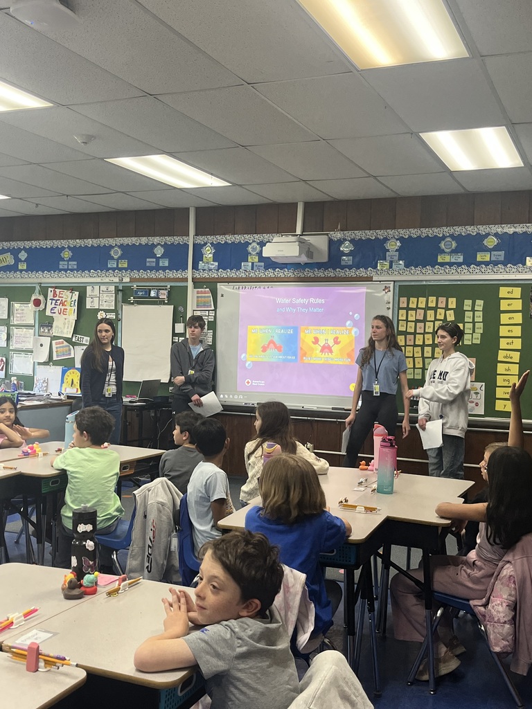 4 WHS presenters talking with our 3rd graders.