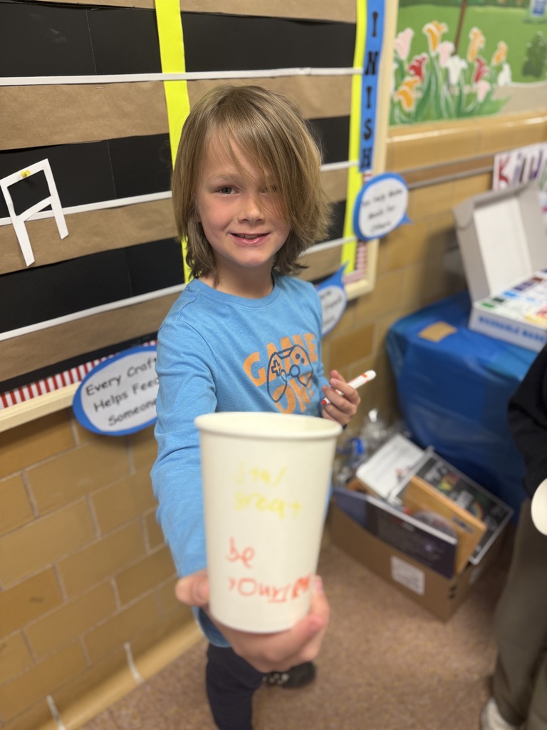 student holding decorated cup