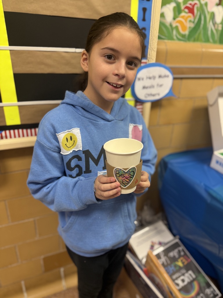 student holding decorated cup