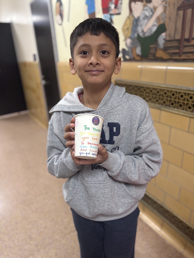 student holding decorated cup