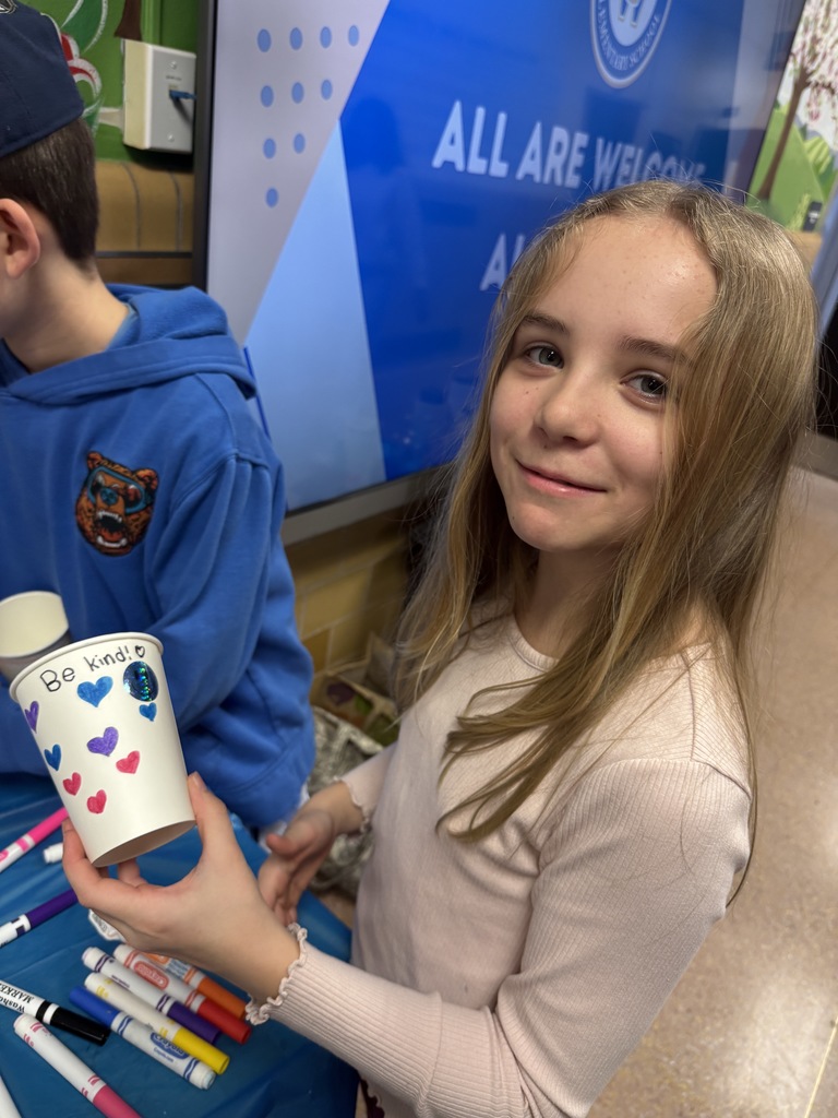 student holding decorated cup