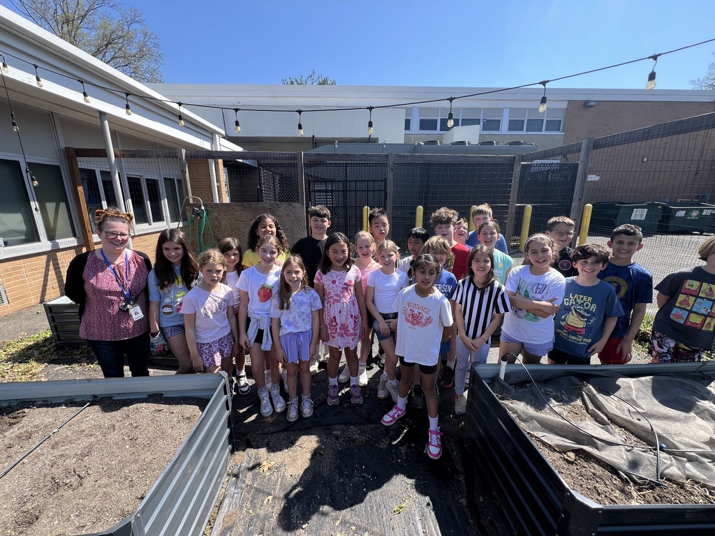 3rd grade class are proud of their weeding job.