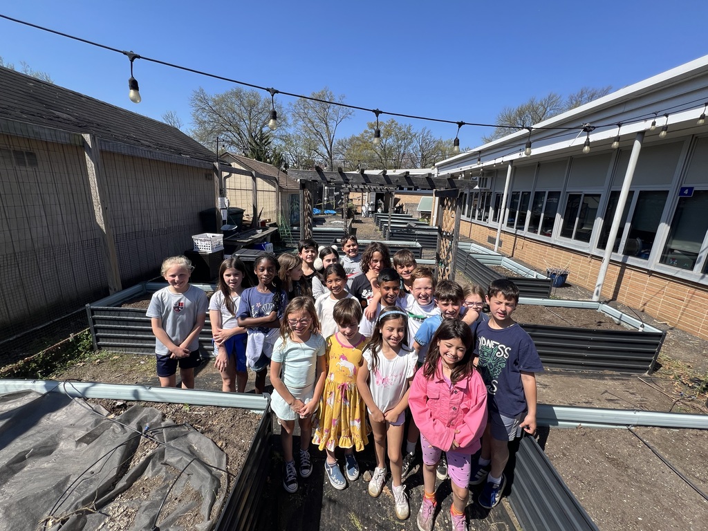 3rd grade class are proud of their weeding job.