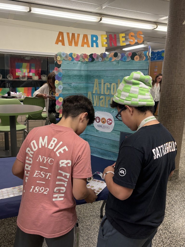 Students playing trivia with Ms. Wilson