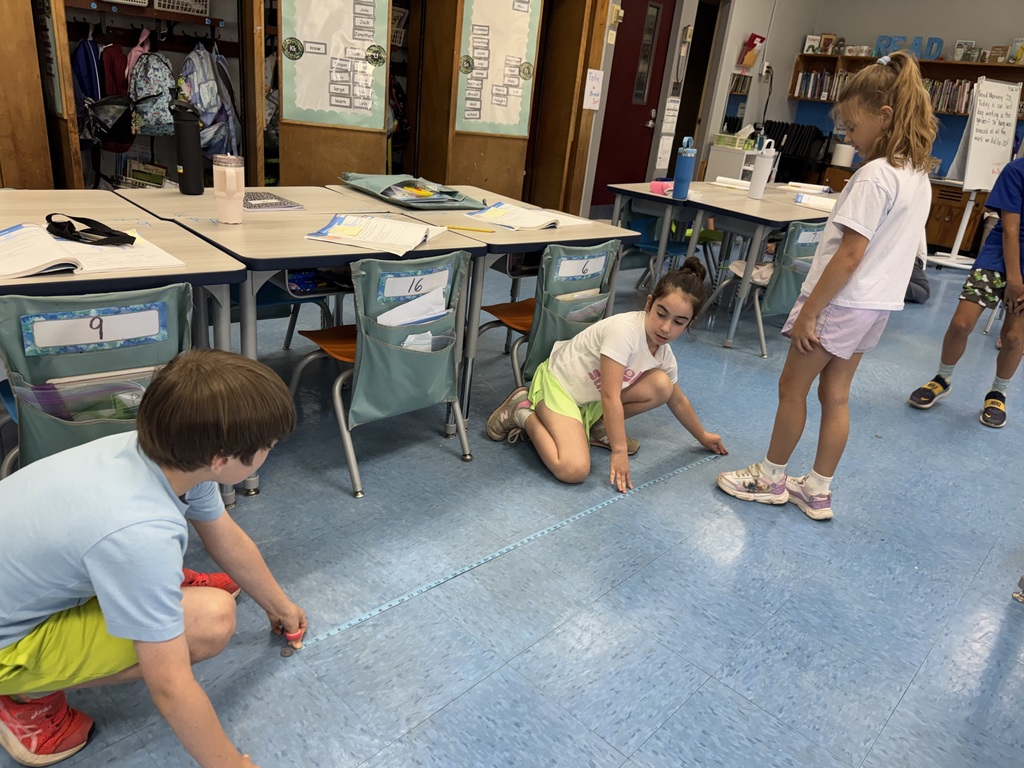 Students measuring how far they can jump.