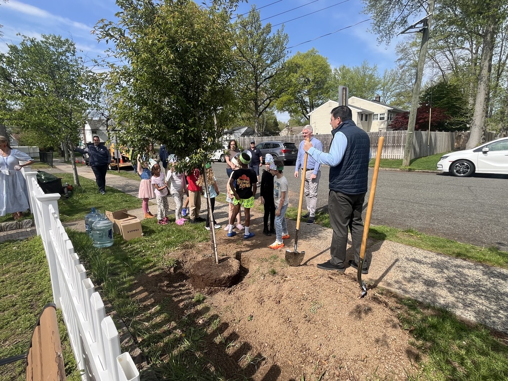 Students line up to help shovel dirt for the new tree.