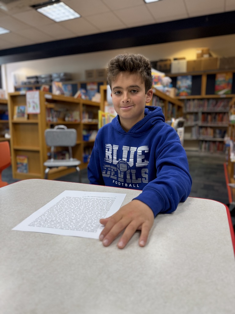 student creating a Black-Out poem