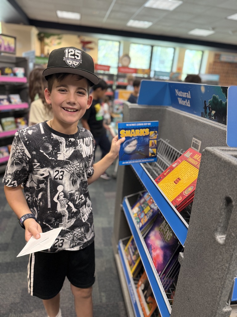 student holding up book at the Book Fair
