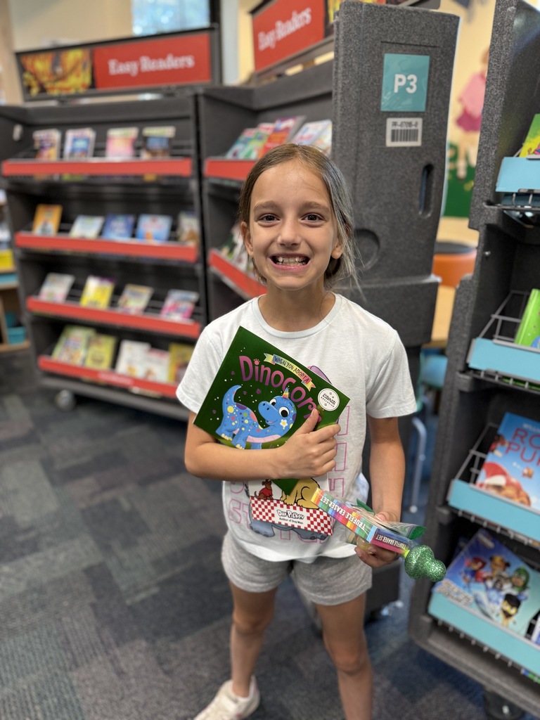 student holding up book at the Book Fair