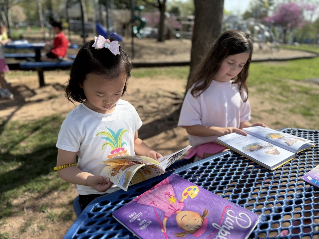 students sitting outside reading