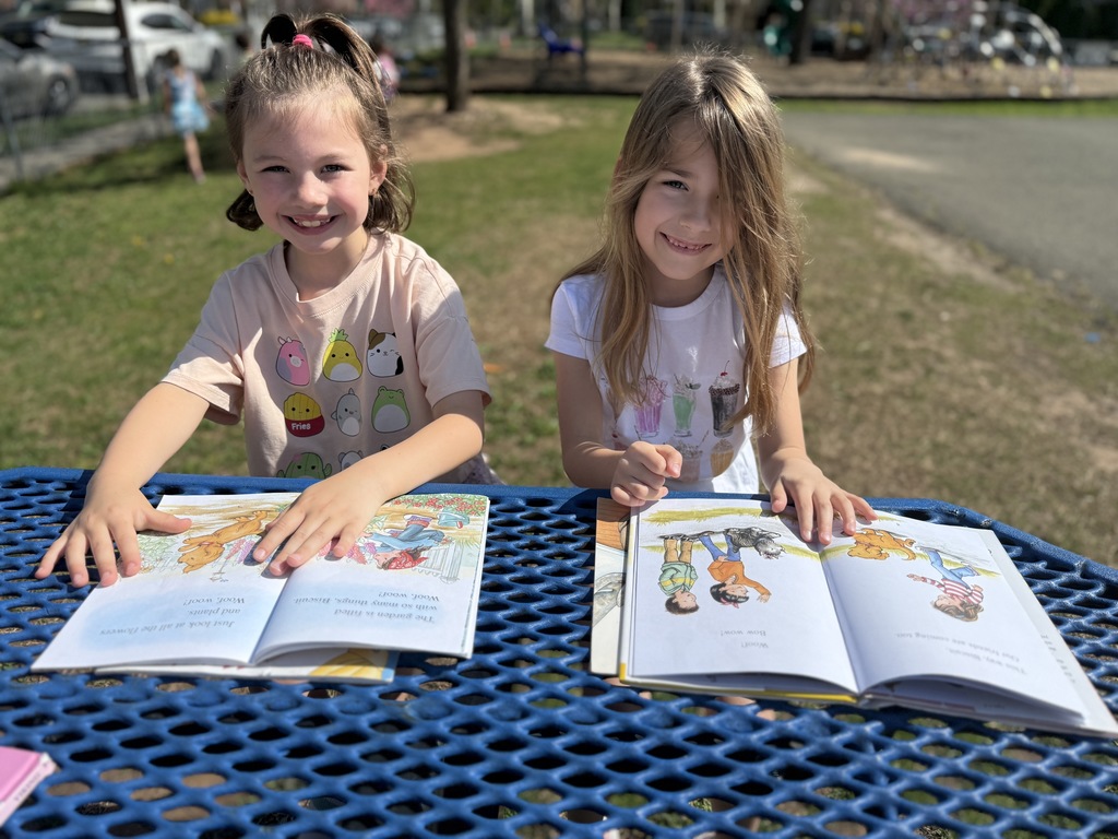 students sitting outside reading