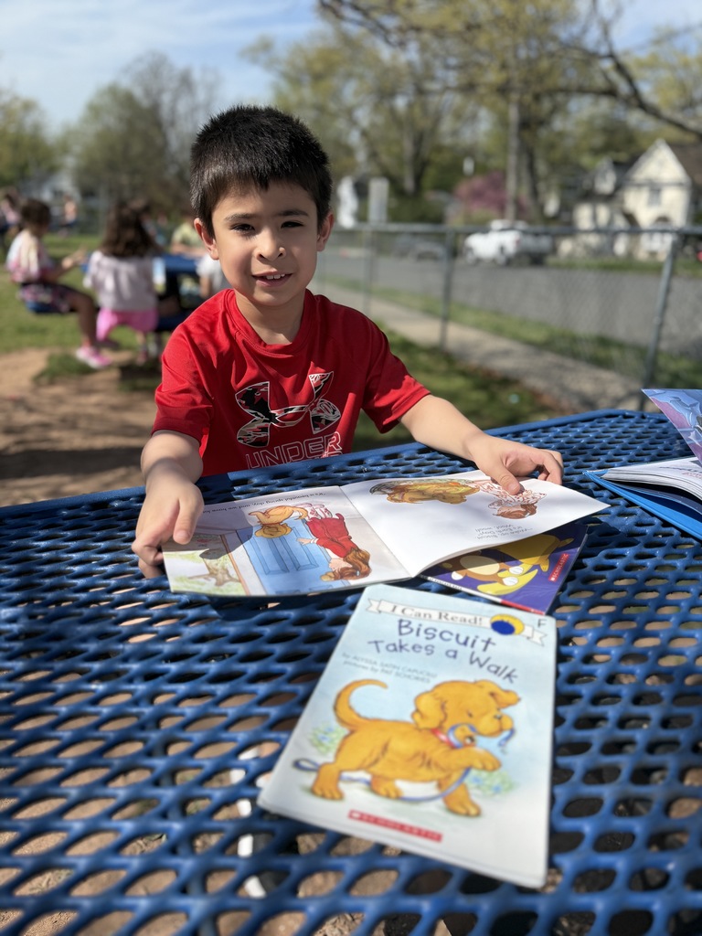student sitting outside reading