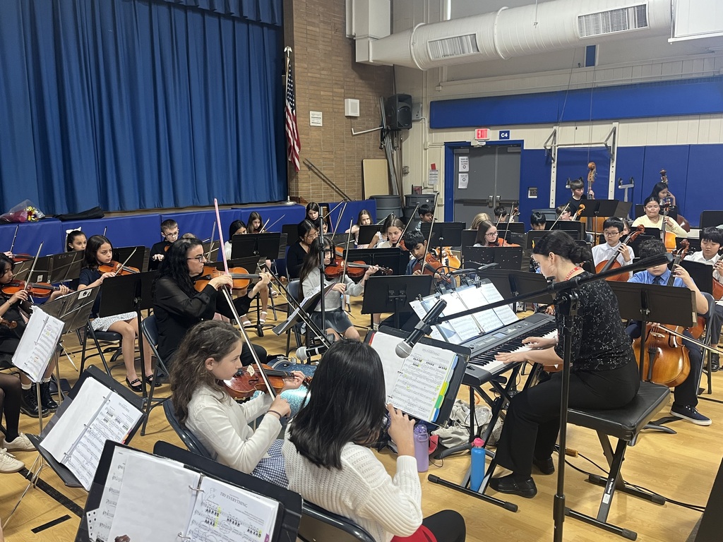 Orchestra students performing with Mrs. Naylor and her daughter on the keyboard