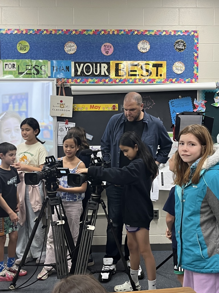 Mr. Alongi guides students in using the cameras.