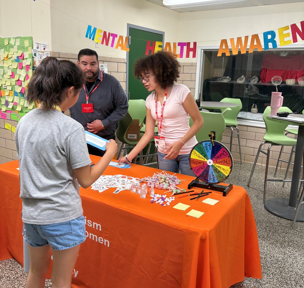 Guests from YWCA hosting healthy relationships table with students 