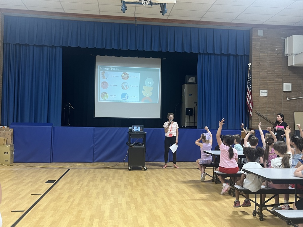 Mrs. Larkin shows the 9 common allergens on the screen.