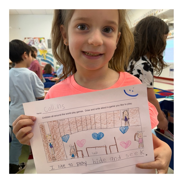 student poses with writing sample