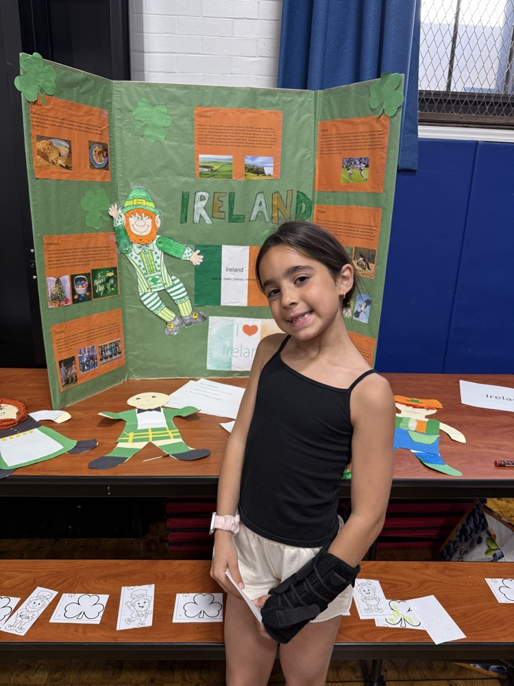 student standing in front of presentation board
