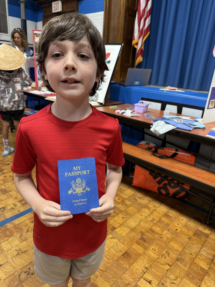 student holding their passport