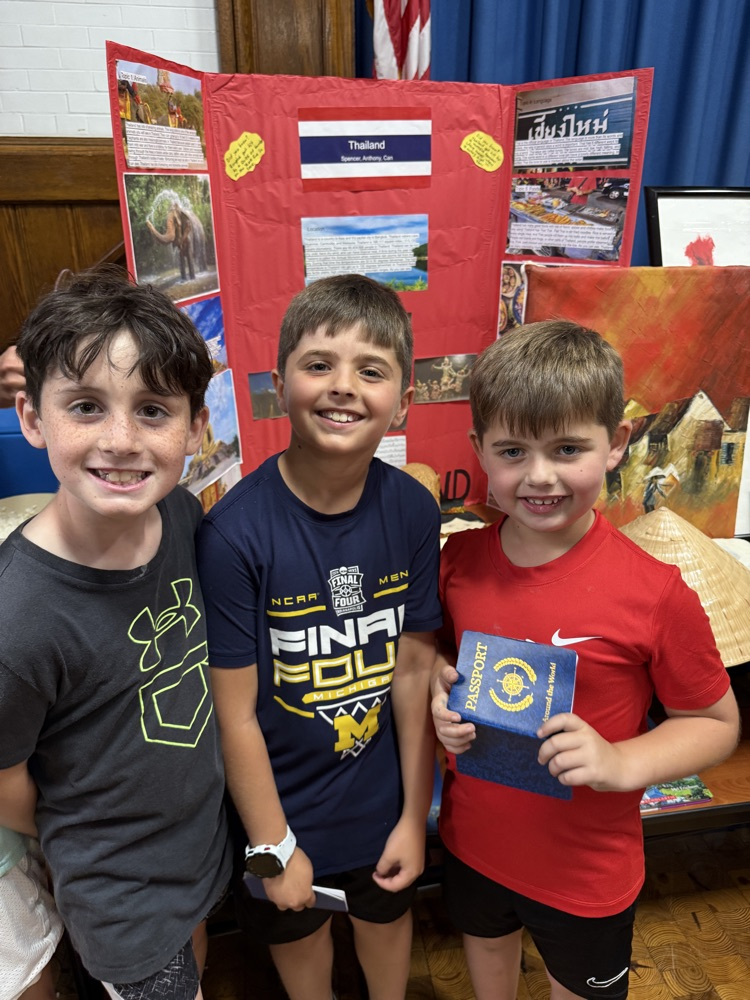 students standing together, holding their passport
