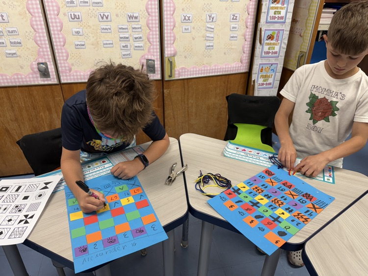 students with their paper weaving projects