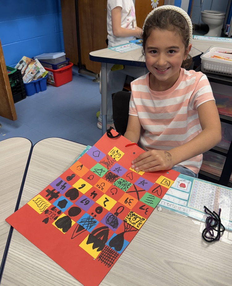 student with their paper weaving project