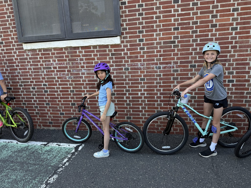 students holding bikes