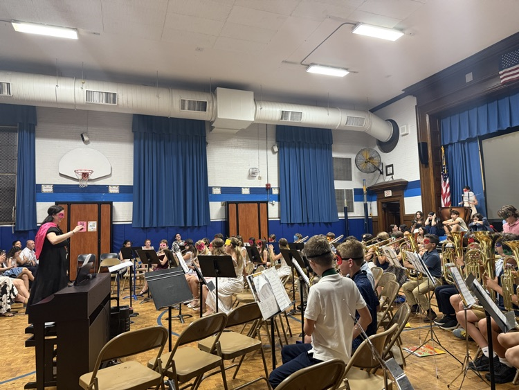 “super-hero” band students playing with Mrs. Webber
