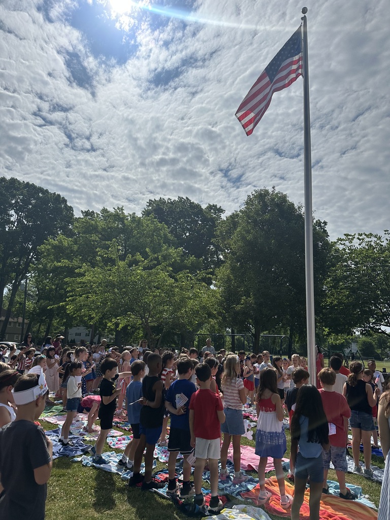 Students saying the Pledge and singing patriotic songs. 