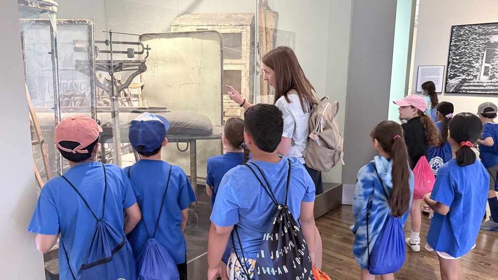 Students and teacher looking at the artifacts.