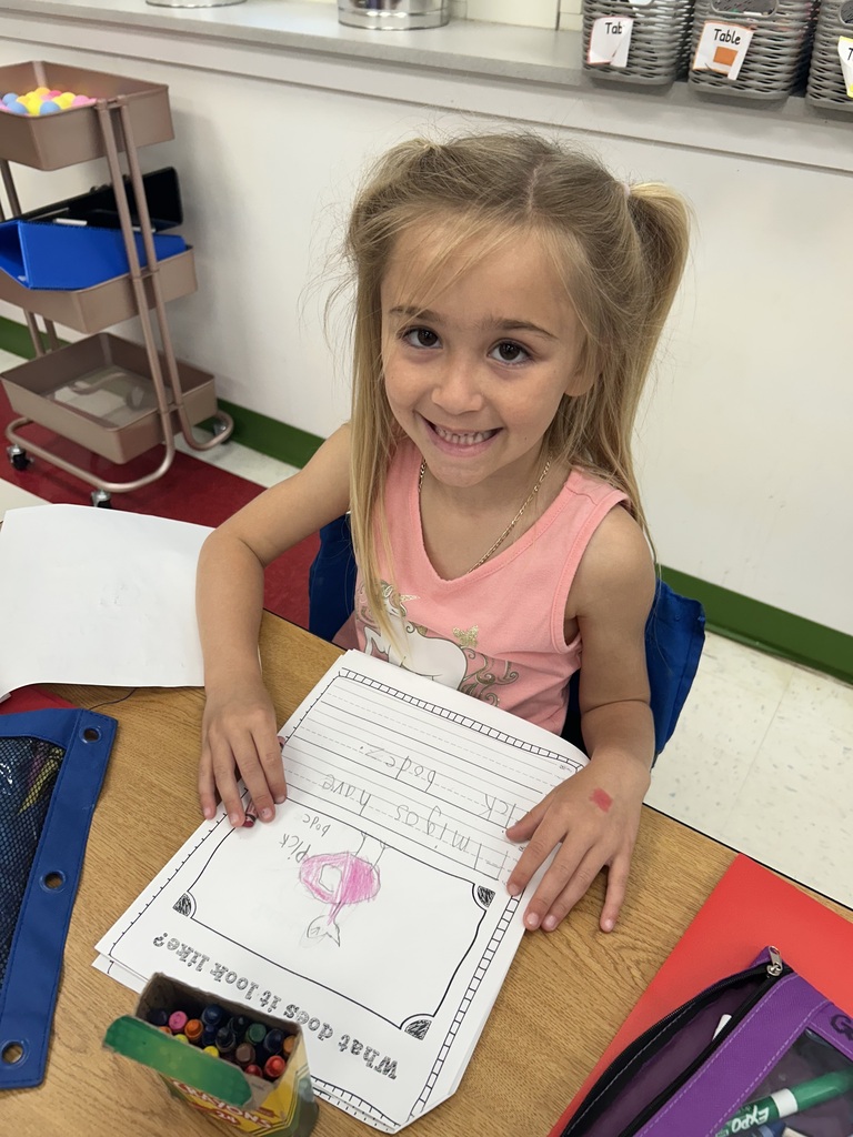 students engaged in reading their All About books