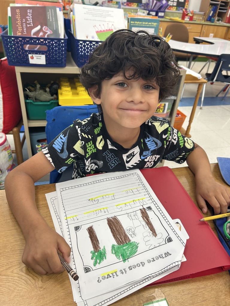students engaged in reading their All About books