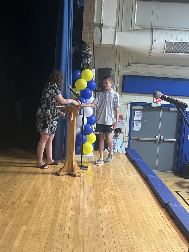 Teacher congratulates one of her students.