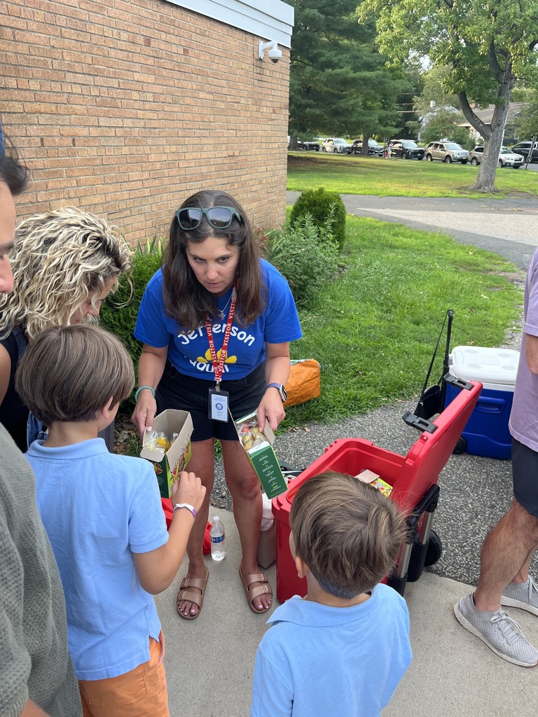 PTO president distributing ice pops to new students.