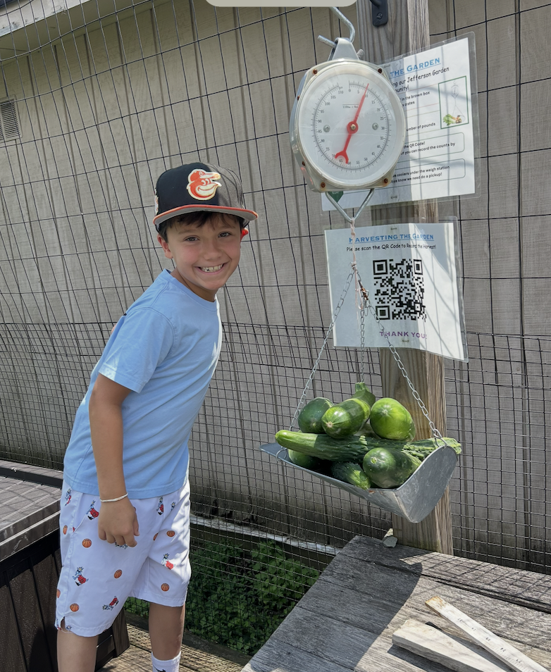 Student is thrilled to see how much the cucumbers weighed.