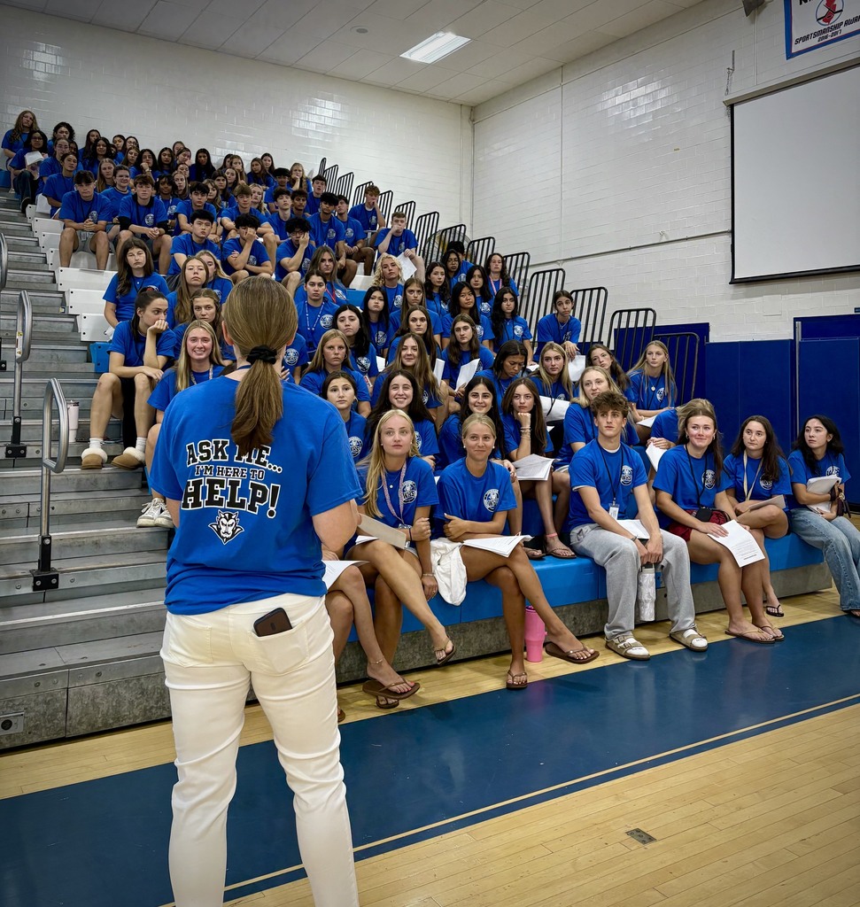 SGA Advisor speaking with a packed gymnasium of new students