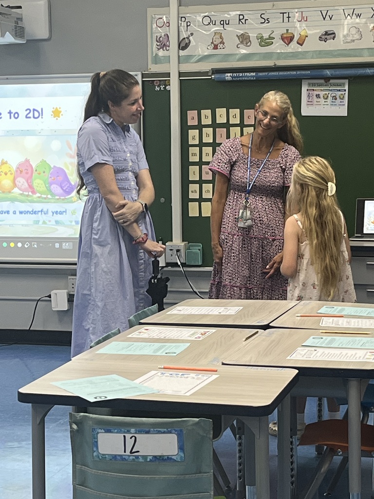 Teacher greets new student and parent