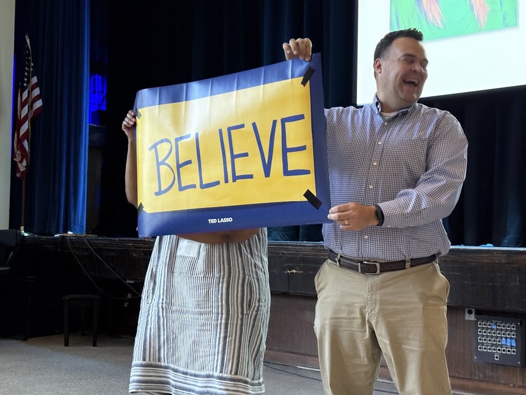 Teachers holding Believe banner