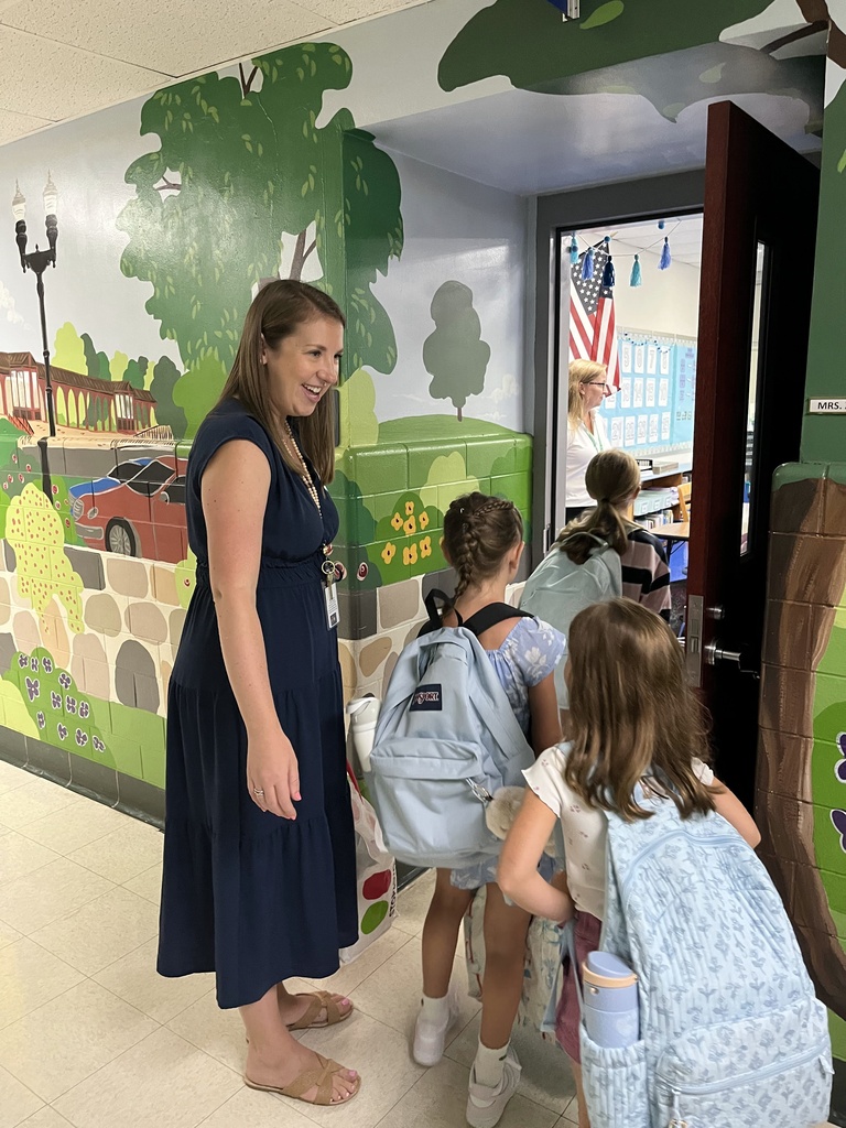 3rd grade teacher greets her new students. 